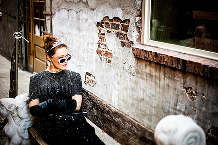woman sitting on bench beside window thumbnail