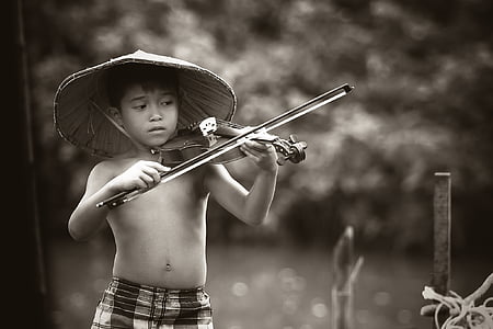 grayscale photography of boy playing violin thumbnail