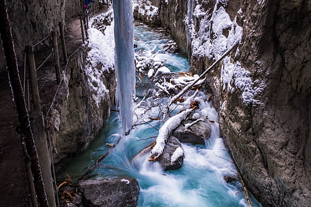 flowing river between two mountains thumbnail