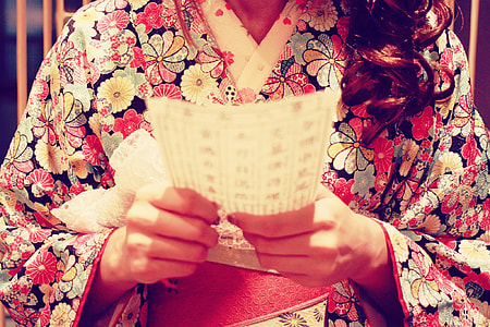 person wearing white, black and red floral kimono thumbnail