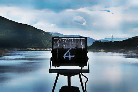 macro photography of black metal frame facing body of water thumbnail