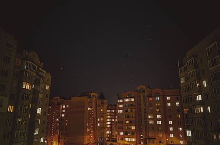 high rise photo of buildings during nighttime thumbnail
