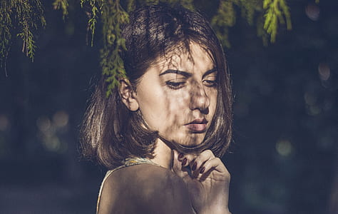 woman's face under green grass thumbnail