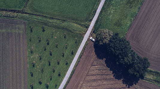 aerial photography of white vehicle on road at daytime thumbnail