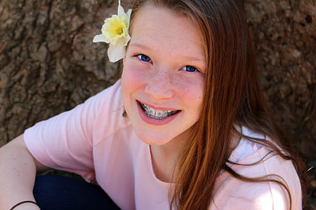 girl smiling wearing pink crew-neck top thumbnail