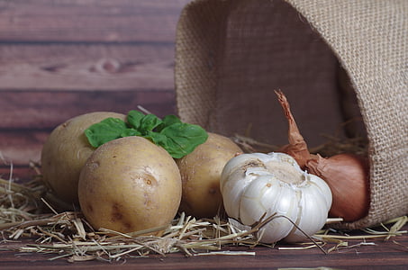 three potatoes, bulb of garlic, and two onions thumbnail