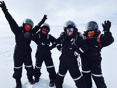 Four Person Wearing Black Snow Suit thumbnail