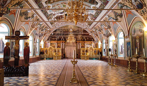 brass-colored candle holders in building thumbnail