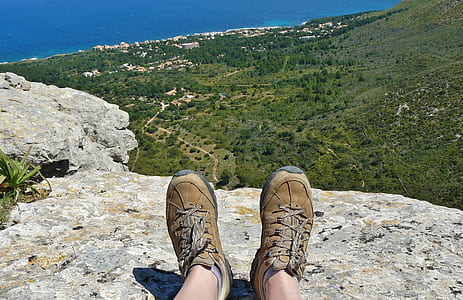 person sitting on gray rock thumbnail