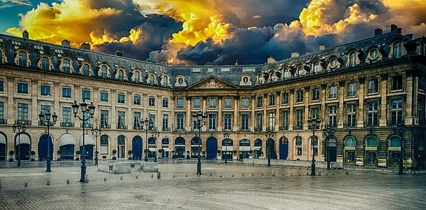 beige building under white clouds during daytime thumbnail