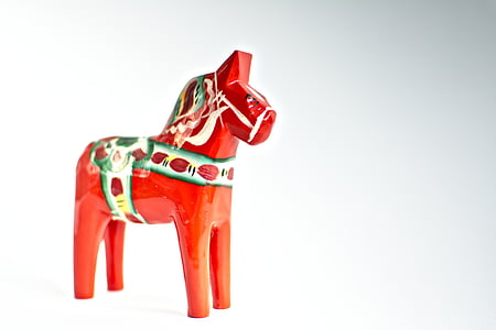 red and white wooden horse figurine thumbnail