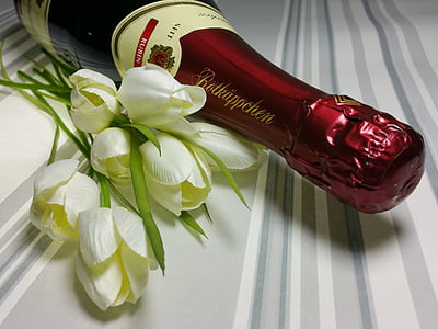 white flowers beside wine bottle thumbnail