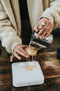 person pouring liquid in mini glass cake thumbnail
