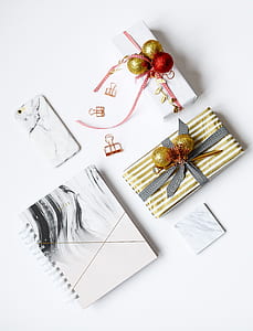 white and gold boxes besides white phone thumbnail