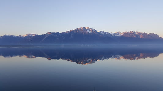 body of water with a scene of mountain thumbnail
