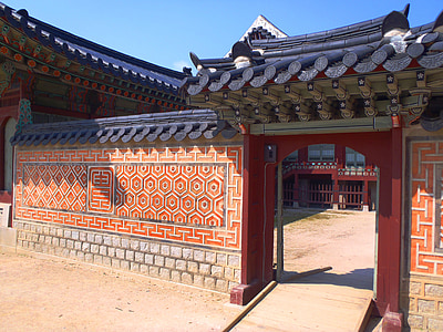 orange, white, and black building under clear blue sky during daytime thumbnail