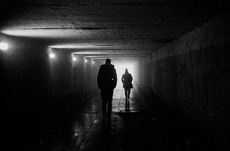 two silhouette persons walking at the cave thumbnail