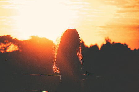 silhouette photo of woman during sunset thumbnail