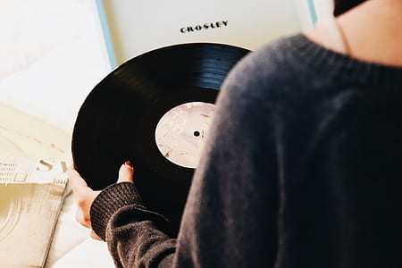 person holding black vinyl record thumbnail