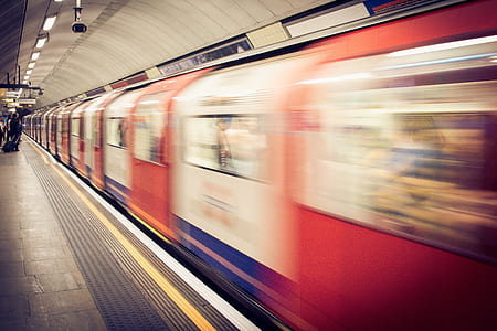 timelapse photo of red and white train thumbnail