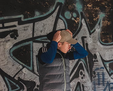man putting hoodie over cap thumbnail