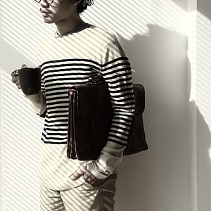 man in black and white pinstriped long-sleeved top thumbnail