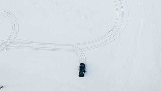 high-angle photography of car on snowfield thumbnail