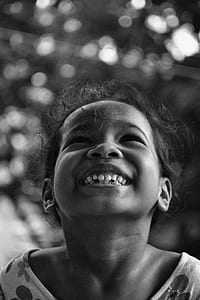 greyscale photo of smiling girl wearing top thumbnail