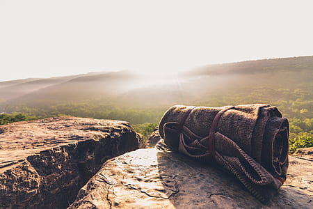black towel rolled on top of rock thumbnail