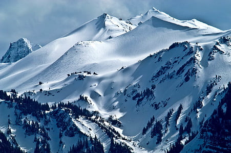 mountain coated with white snow during daytime thumbnail