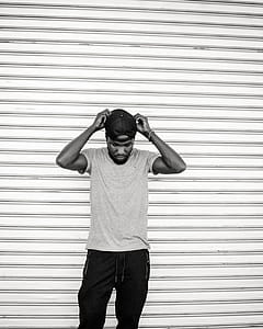 Monochrome Photo of Man Holding His Cap thumbnail