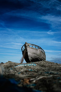 gray boat on top gray soil outdoor thumbnail