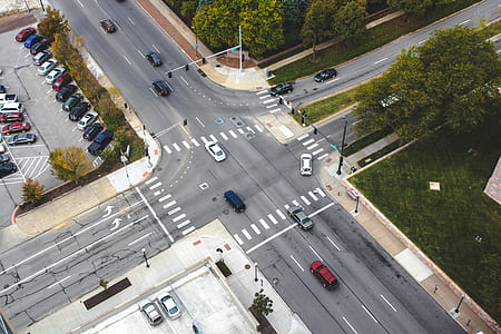 aerial photography of vehicles cross at cross intersection at daytime thumbnail
