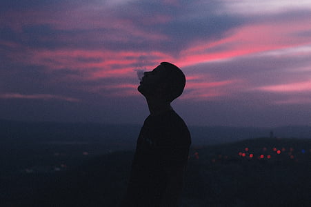 silhouette of man smoking at blue hour thumbnail