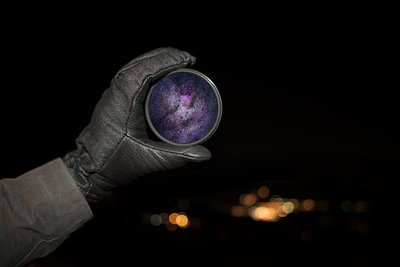 person holding round purple ornament thumbnail