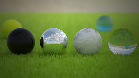 six assorted-color marble balls on green field thumbnail