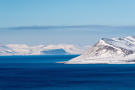 photo of mountains filled with snow near body of water thumbnail