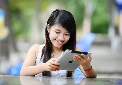 woman holding iPad in front table thumbnail