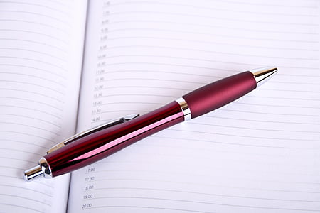 red retractable pen on ruled paper thumbnail