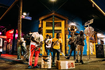 group of people holding musical instrument standing on pavement thumbnail