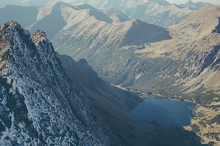 lake between mountain during daytime thumbnail
