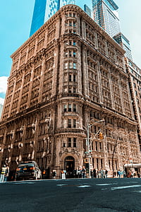 people in front of brown concrete building thumbnail