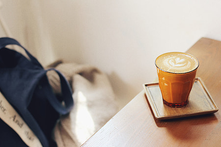 brown ceramic mug filled with latte thumbnail