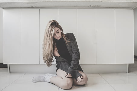 woman in black top sitting on floor thumbnail