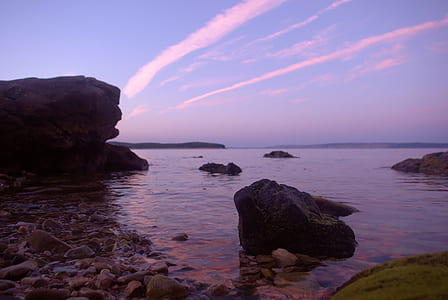 Rock Formation on Body of Water Under Altostratus Clouds thumbnail