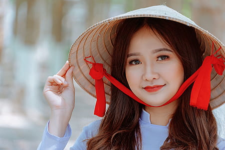 Woman Wearing Conical Hat and Gray Shirt thumbnail