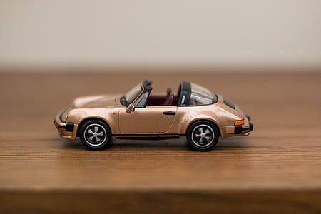 brown convertible car scale model in shallow focus shot thumbnail