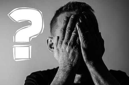 grayscale photography of man covering his face with his hands thumbnail