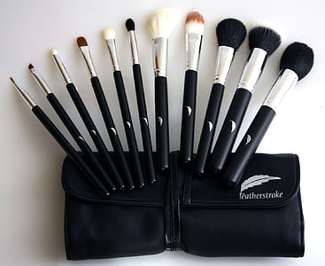 black-and-gray makeup brush set on white wooden board thumbnail