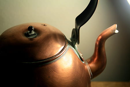 selective focus photography of brass kettle thumbnail